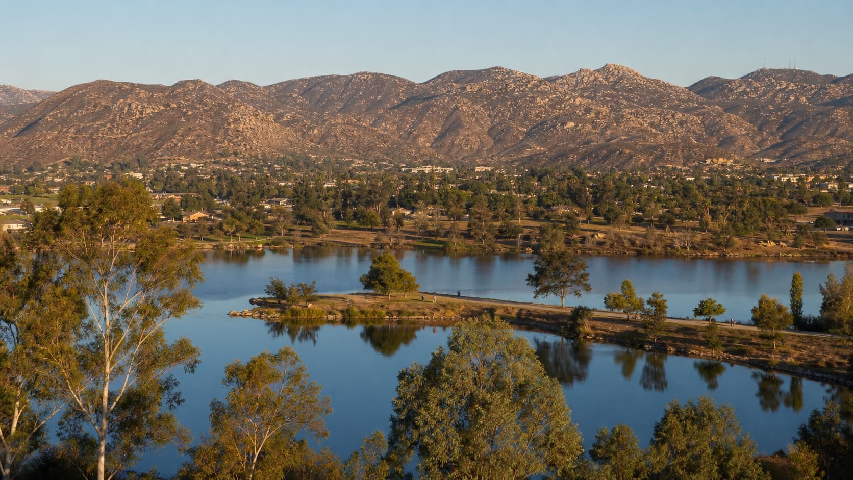 Blue lakes below Santee's granite foothills in late-day light